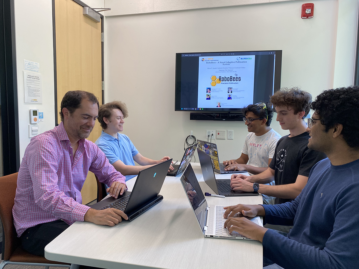 Team of people work together at a table indoors