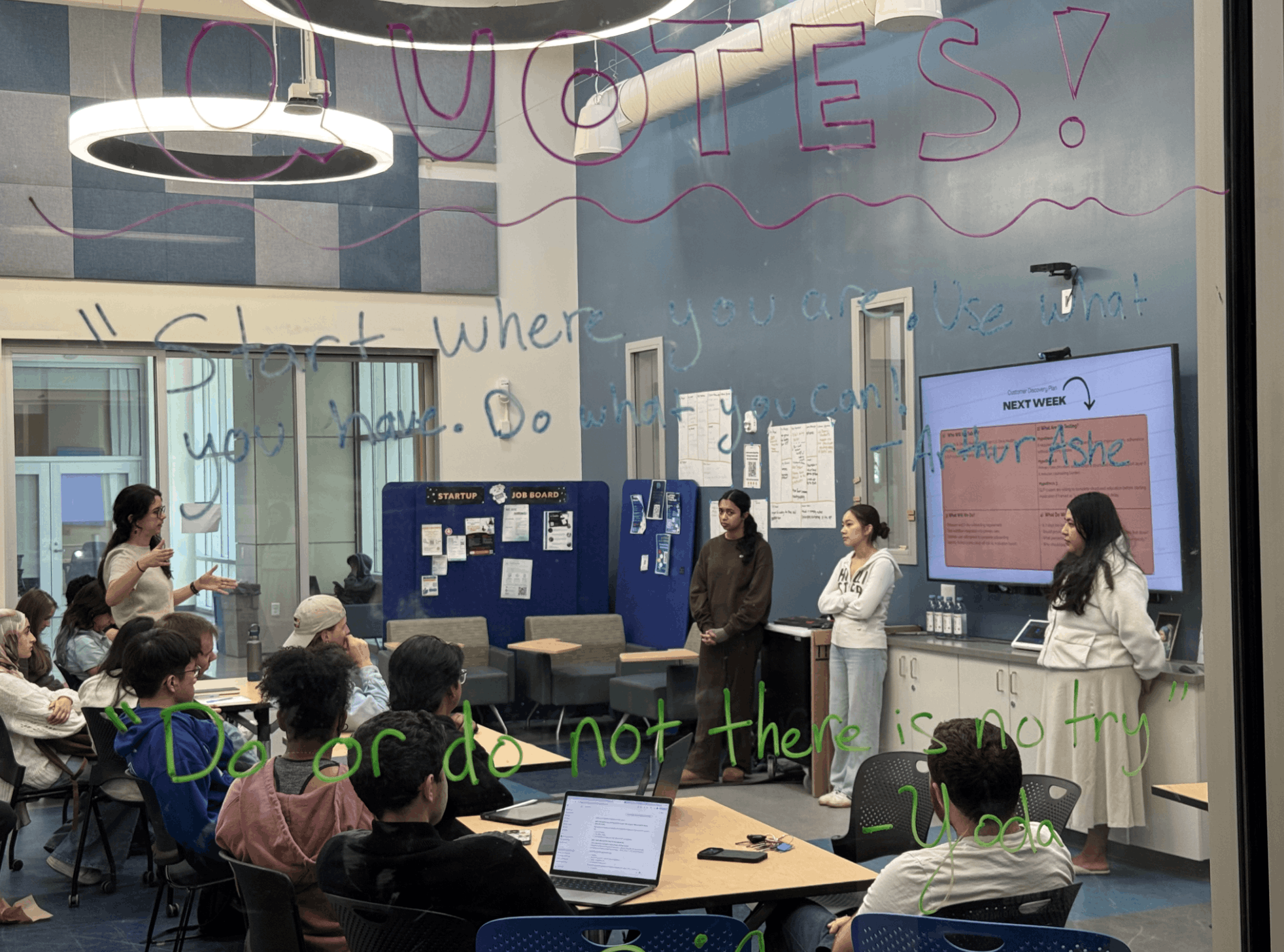 Instructors providing feedback to three student presenters