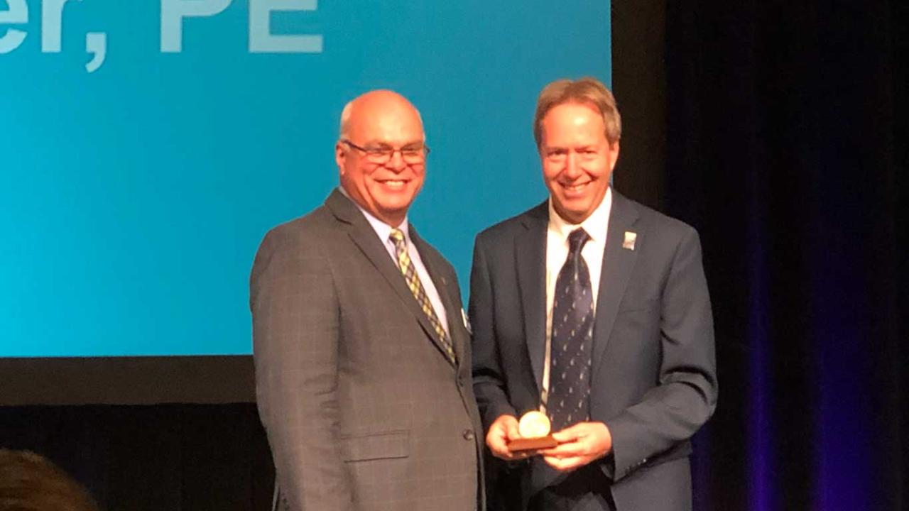 Maury Salz and David Slaughter with award