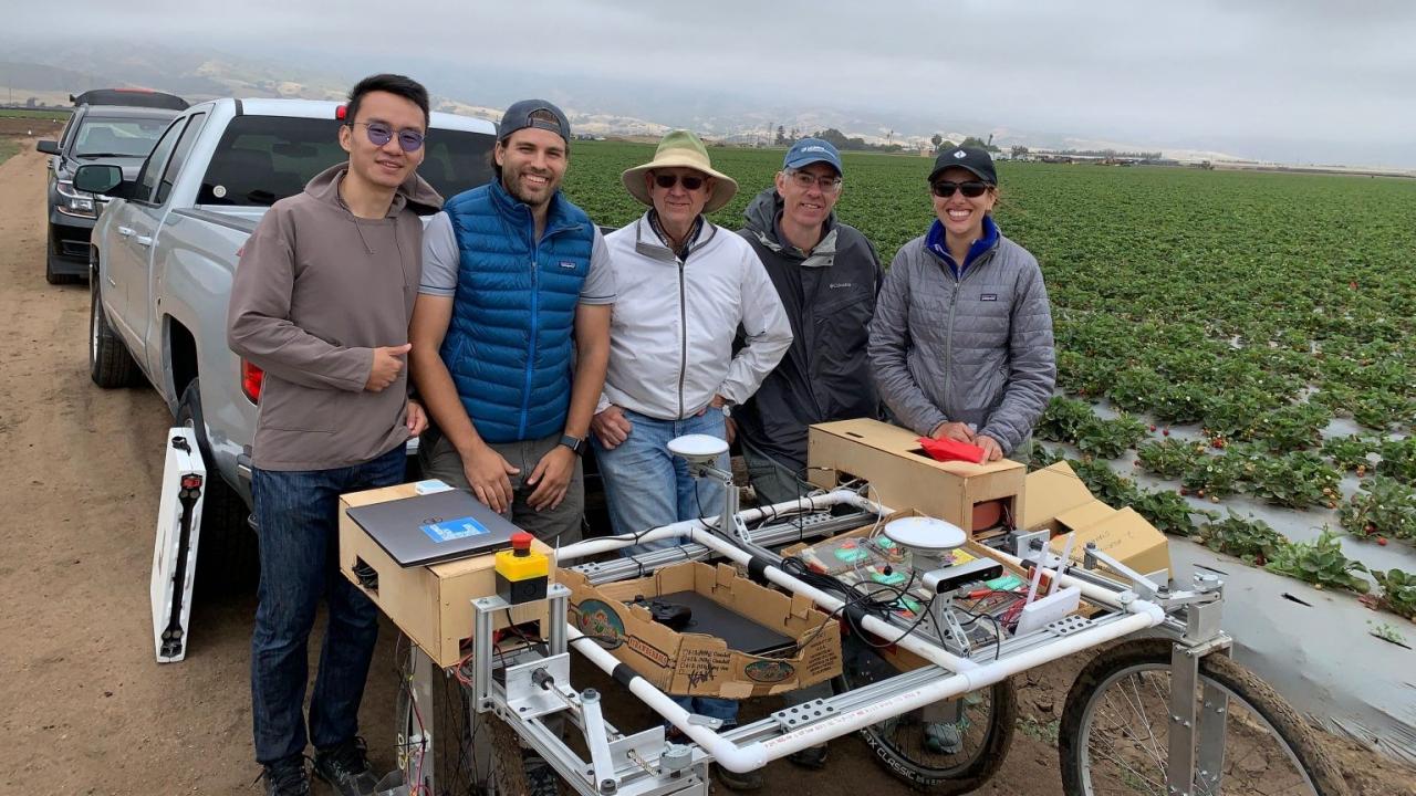 Vougioukas with lab members and the strawberry harvest-aid FRAIL-bot. Photo courtesy of Stavros Vougioukas. uc davis biological agricultural engineering harvest robots stavros vougioukas