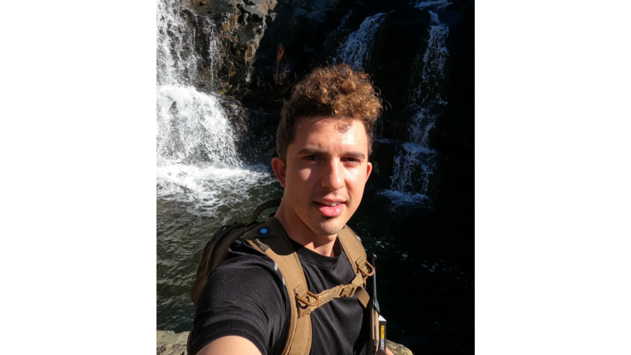 Picture of Bradley Soares in front of a waterfall