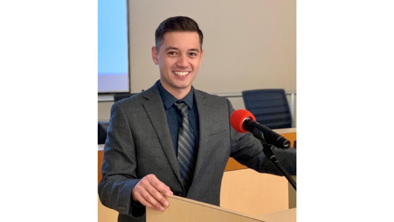 Picture of Brandon Roosenboom at a podium