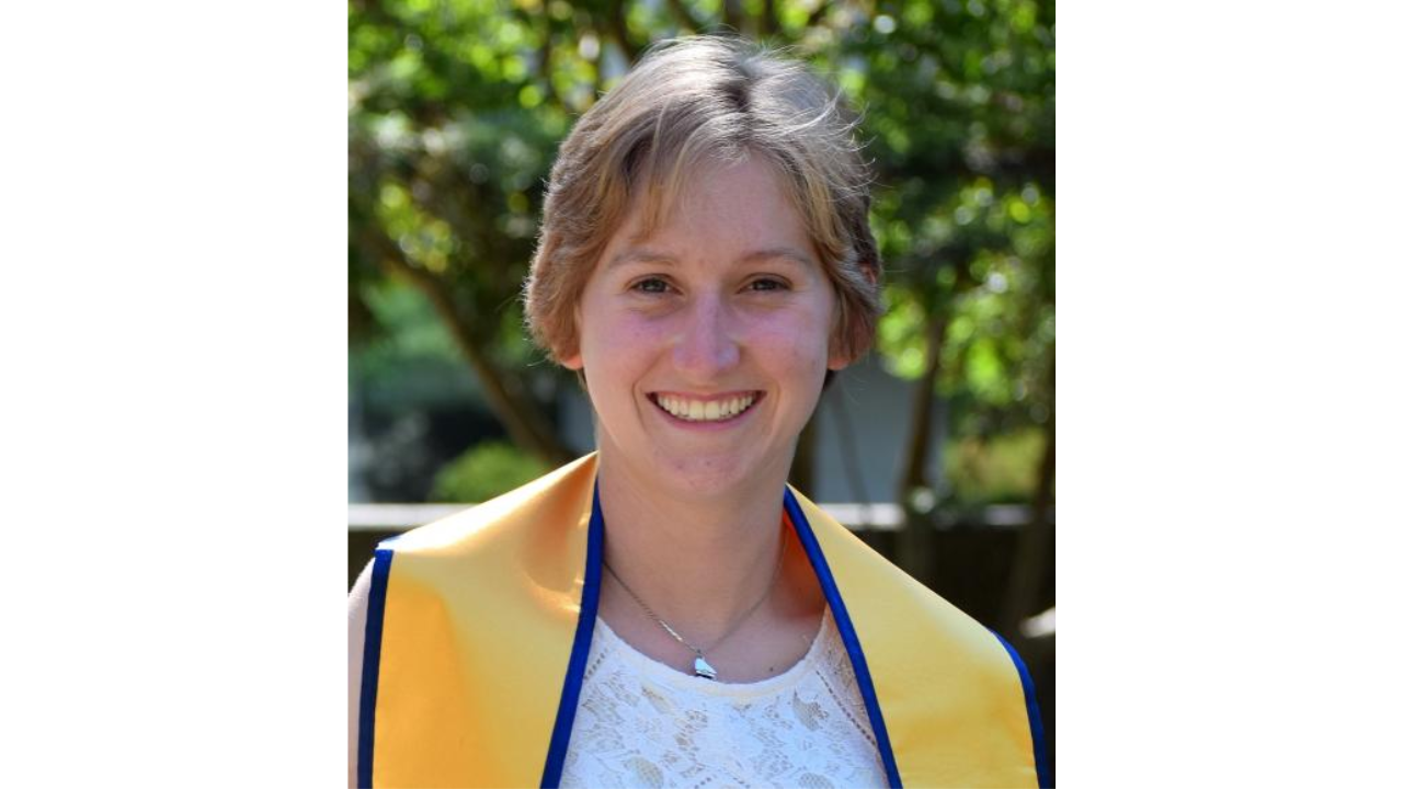 Portrait of Julie Meyers wearing a graduation stole