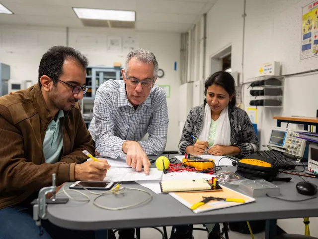 Stavros Vougioukas with two senior undergraduate students