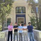 Five people stand outside of an engineering building on the UC Davis campus
