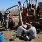 researchers in the field collecting water samples